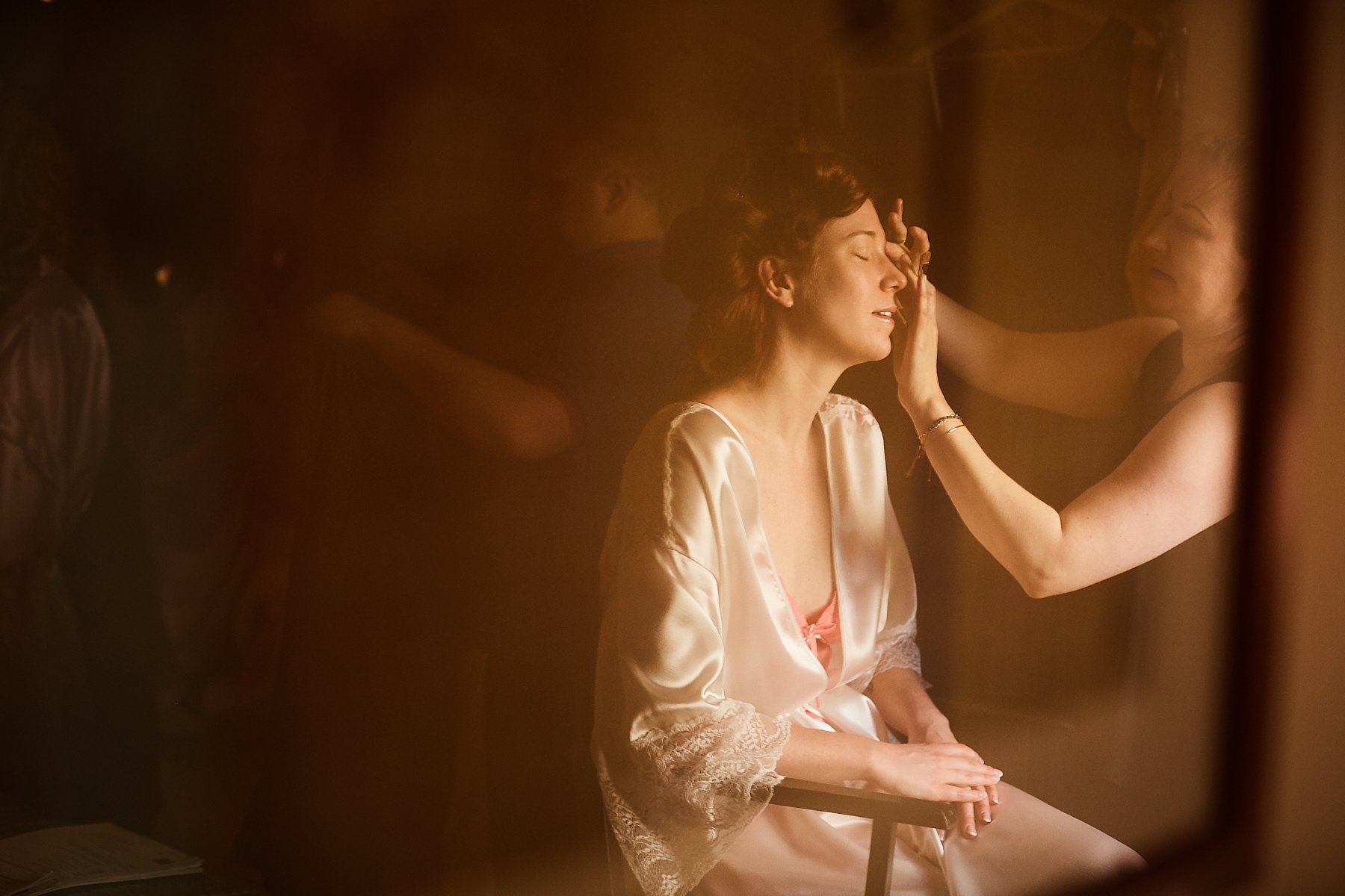 creative picture bride having makeup applied