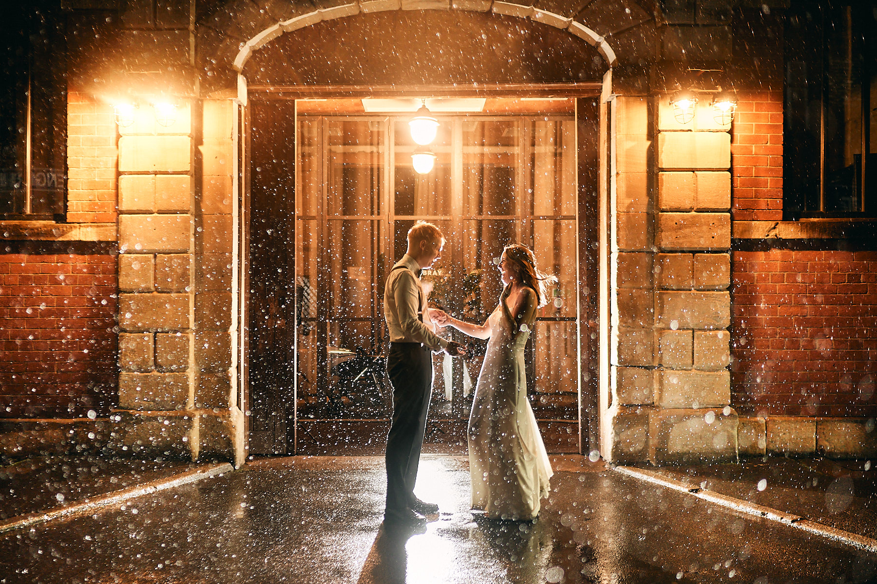 Romantic picture of newly wed couple in rain outside the mowbray in sheffield